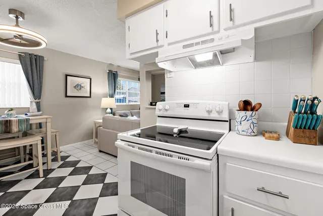 a kitchen with a stove a sink and a microwave