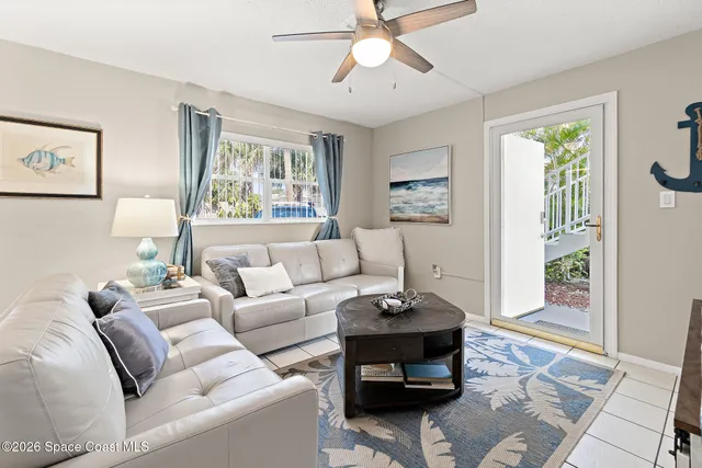 a living room with furniture a window and a table