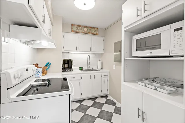 a kitchen with stainless steel appliances a stove a sink and a refrigerator