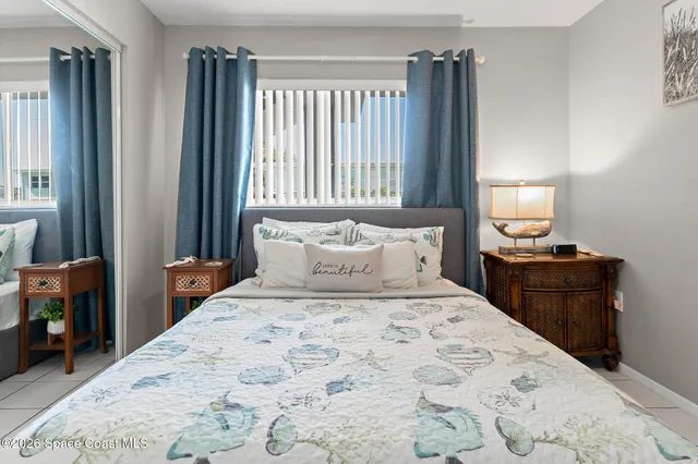 a living room with furniture a large window and a flat screen tv