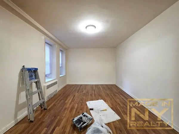 a view of a room with wooden floor