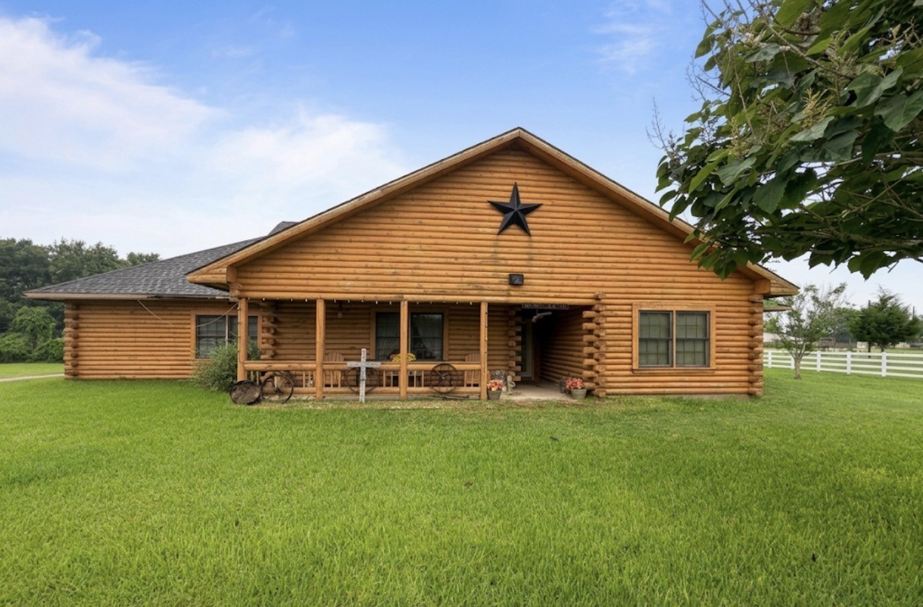 a front view of house with yard and green space
