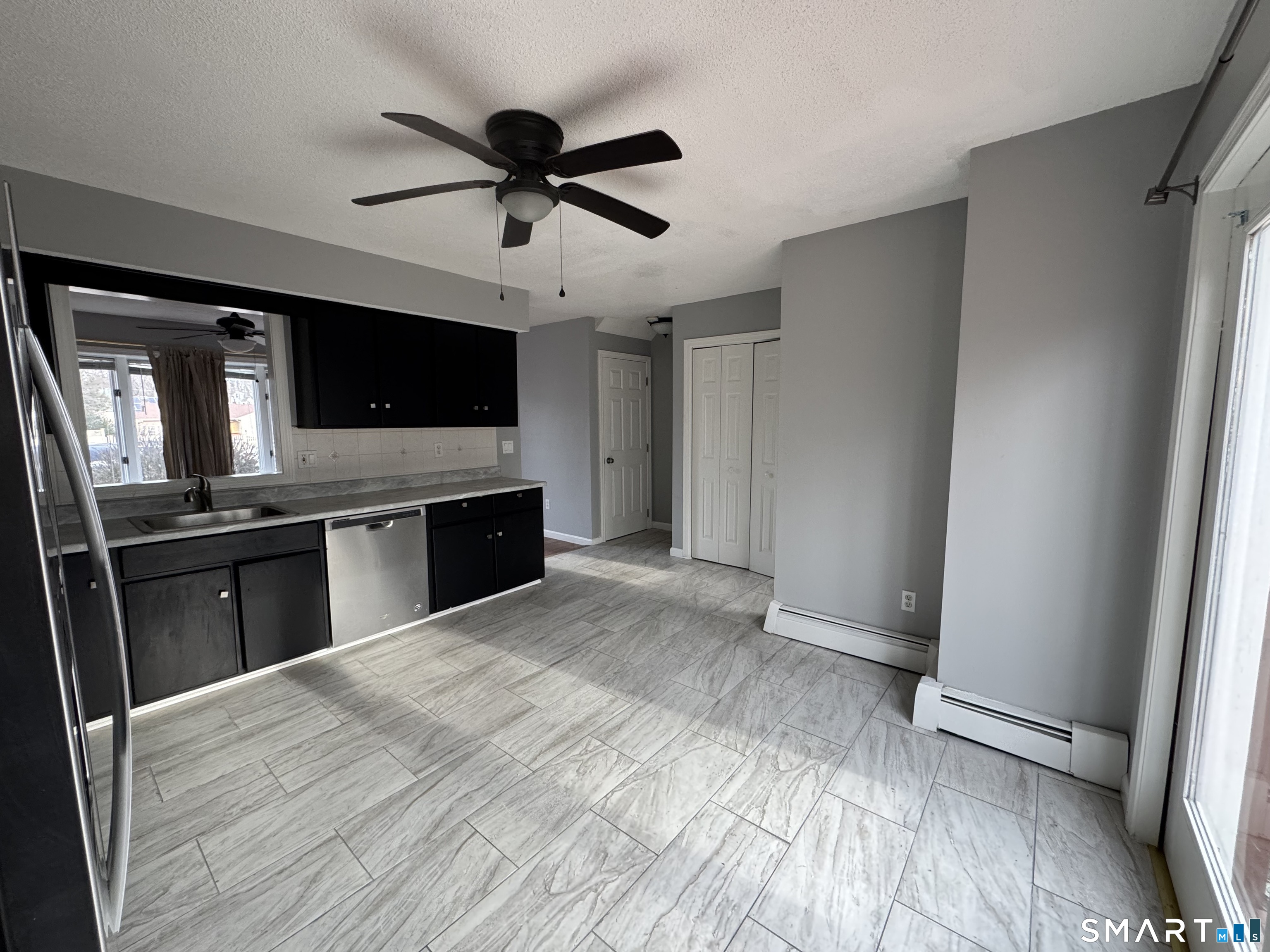 27 Katie Lane Waterbury, CT 06708 - Photo 4 of 14 a view of a kitchen with a sink a ceiling fan and wooden floor