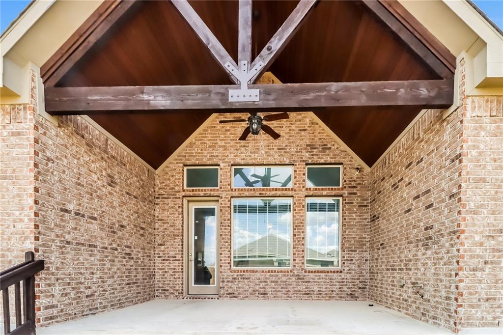 21301 Resource Road Pflugerville, TX 78660 - Photo 21 of 29 Covered outdoor patio featuring a vaulted wood-paneled ceiling with exposed beams, ceiling fan, and brick exterior walls