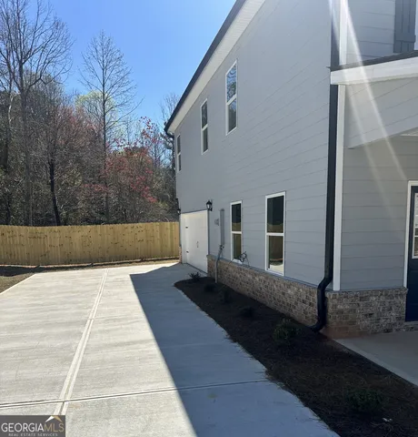 a kitchen with stainless steel appliances a refrigerator a sink dishwasher with a dining table and chairs