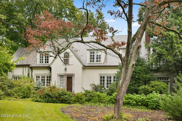 a front view of a house with a garden