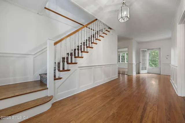 a view of entryway and hall with wooden floor