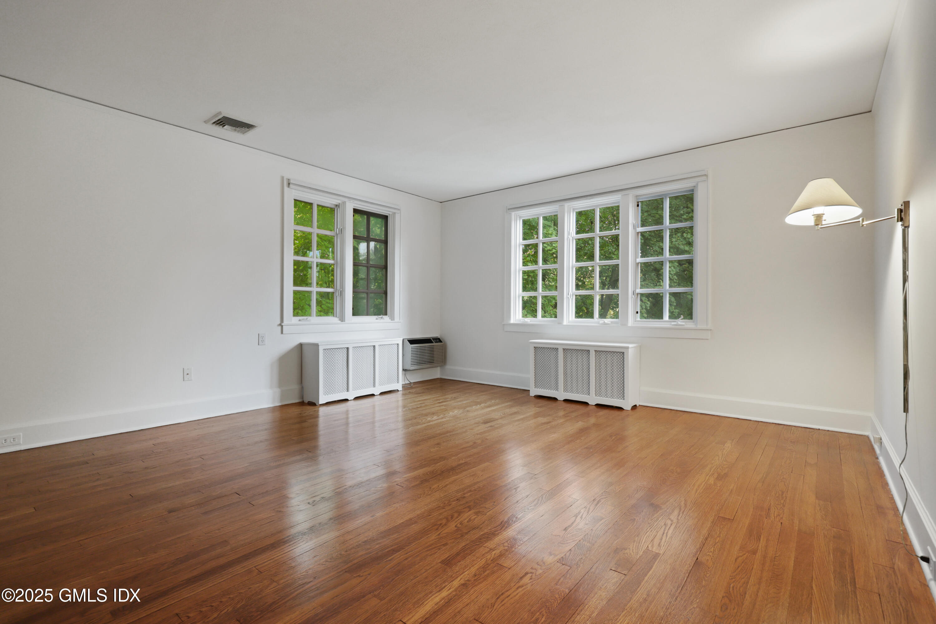 11 Stanwich Road Greenwich, CT 06830 - Photo 15 of 25 an empty room with wooden floor and windows
