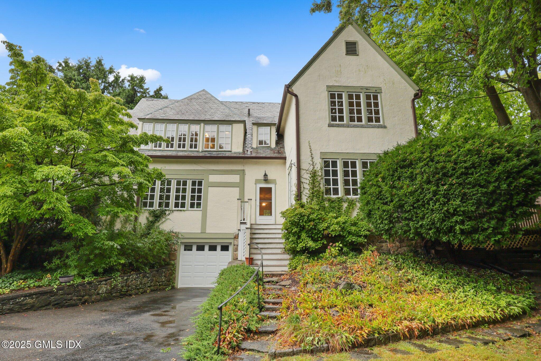 11 Stanwich Road Greenwich, CT 06830 - Photo 23 of 25 a front view of a house with a yard and garage
