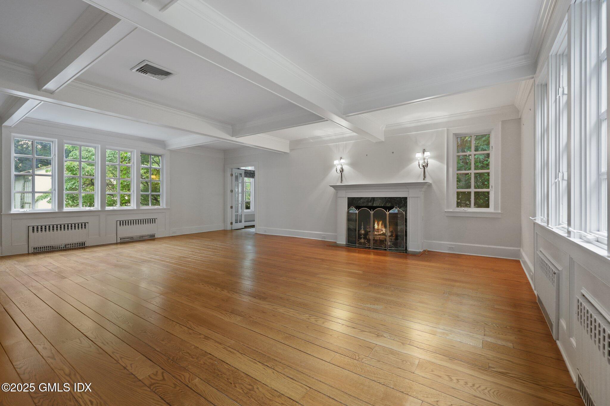 11 Stanwich Road Greenwich, CT 06830 - Photo 3 of 25 an empty room with wooden floor fireplace and windows