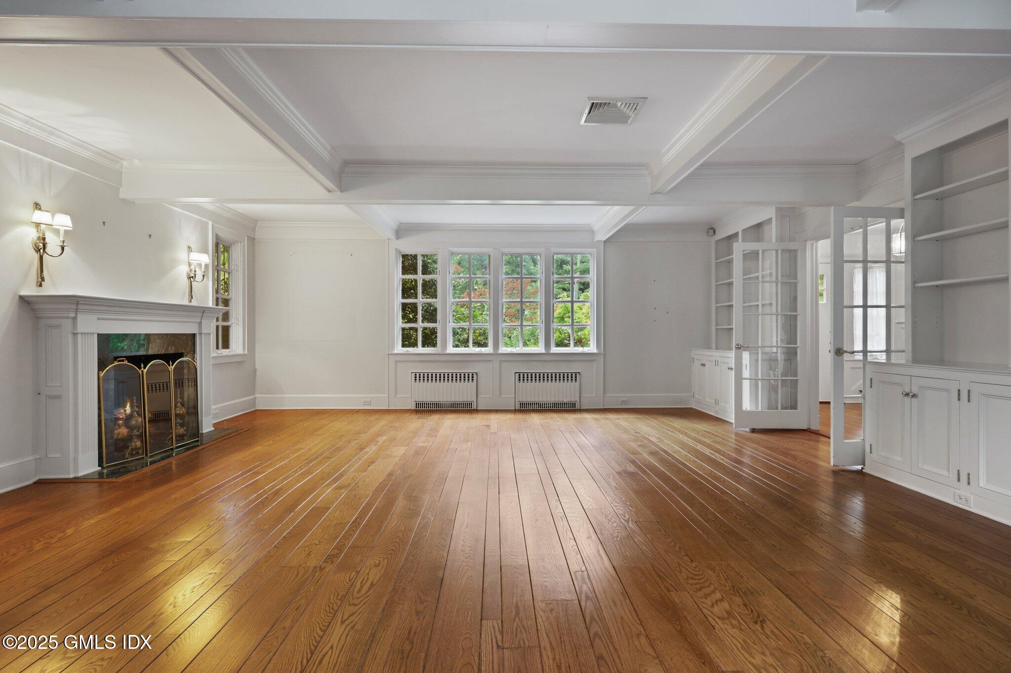 11 Stanwich Road Greenwich, CT 06830 - Photo 4 of 25 an empty room with wooden floor and fireplace