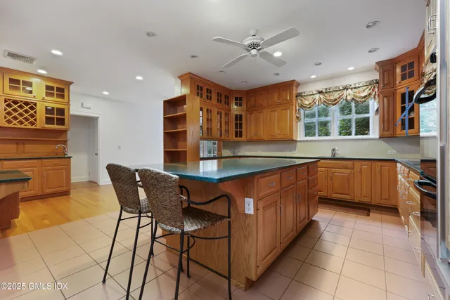 a kitchen with stainless steel appliances granite countertop a sink and a refrigerator