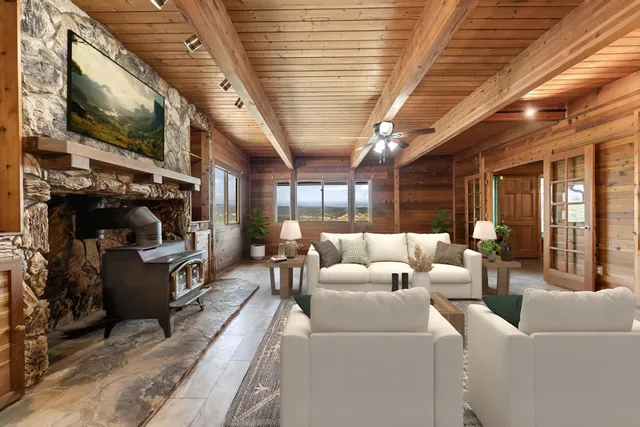 a view of a swimming pool with sitting area and entertaining space