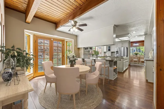 a dining room with furniture and wooden floor