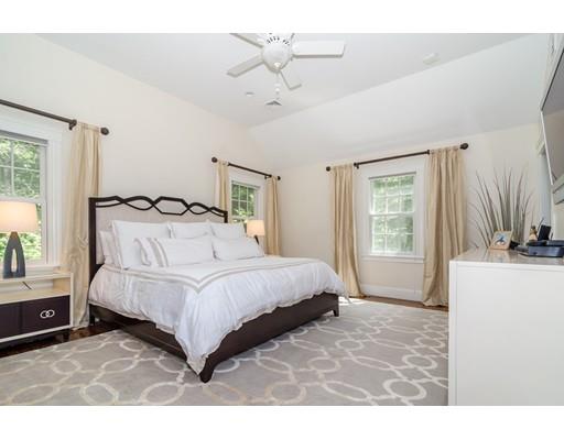 1 Dean Road Wellesley, MA 02481 - Photo 11 of 17 a bedroom with a bed next to a window with a chandelier