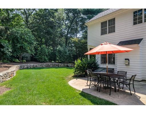 1 Dean Road Wellesley, MA 02481 - Photo 17 of 17 a patio with a table and chairs under an umbrella