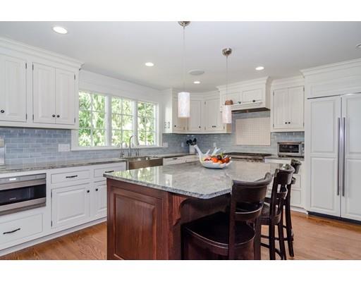 1 Dean Road Wellesley, MA 02481 - Photo 4 of 17 a kitchen with a stove a sink a kitchen island with a dining table and chairs