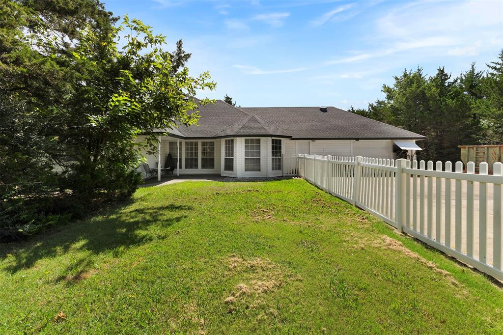 401 Rugged Drive Red Oak, TX 75154 - Photo 35 of 40 White exterior with bay windows and a dark shingle roof