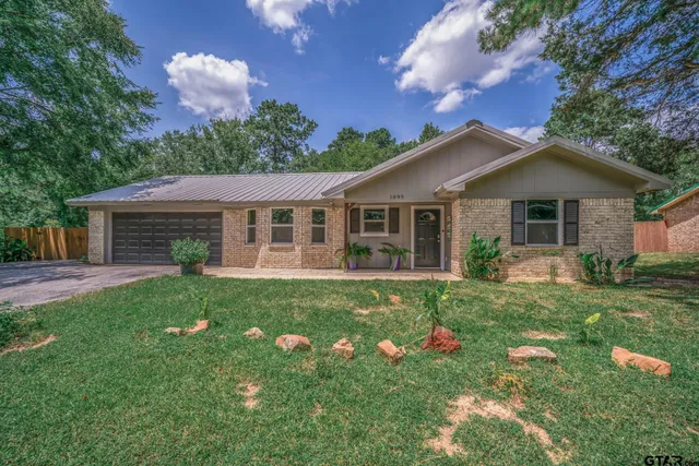 a view of a house with a yard and porch