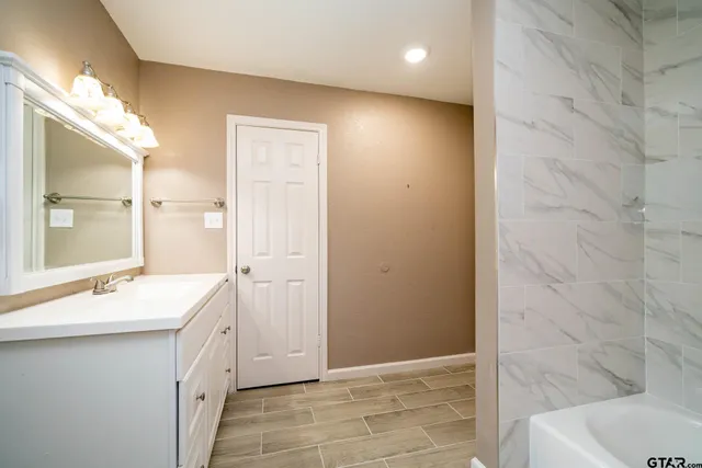 a bathroom with a toilet and a bathtub