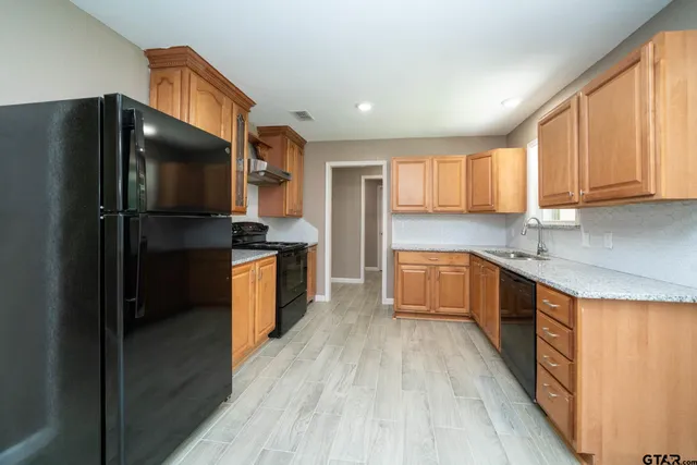 a kitchen with a refrigerator and a stove
