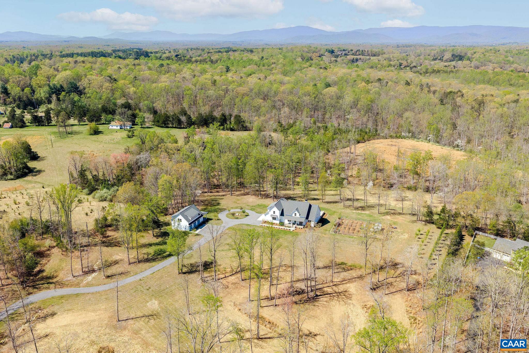 4764 Advance Mills Road Earlysville, VA 22936 - Photo 71 of 72 a view of a lake with mountains in the background