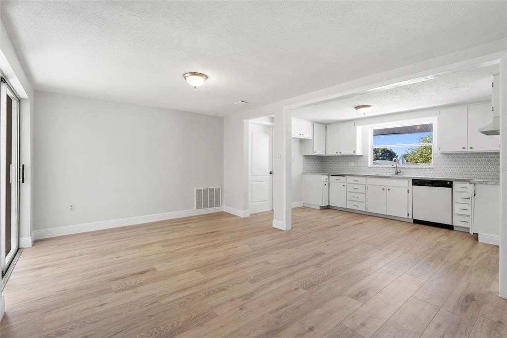 10536 Laburnum Drive Port Richey, FL 34668 - Photo 12 of 33 a view of a kitchen with a sink cabinets and wooden floor