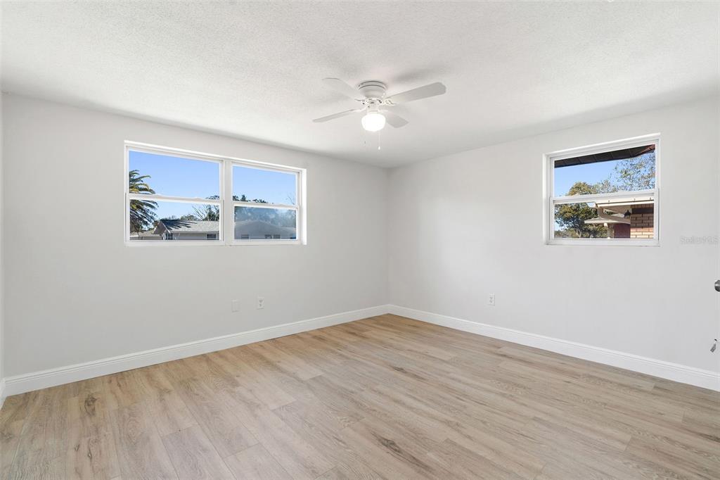 10536 Laburnum Drive Port Richey, FL 34668 - Photo 16 of 33 a view of a big room with wooden floor and windows in a room
