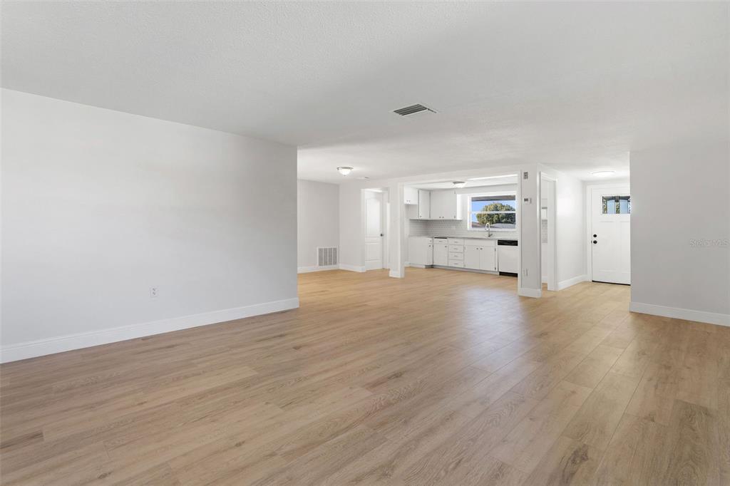 10536 Laburnum Drive Port Richey, FL 34668 - Photo 8 of 33 a view of empty room with wooden floor