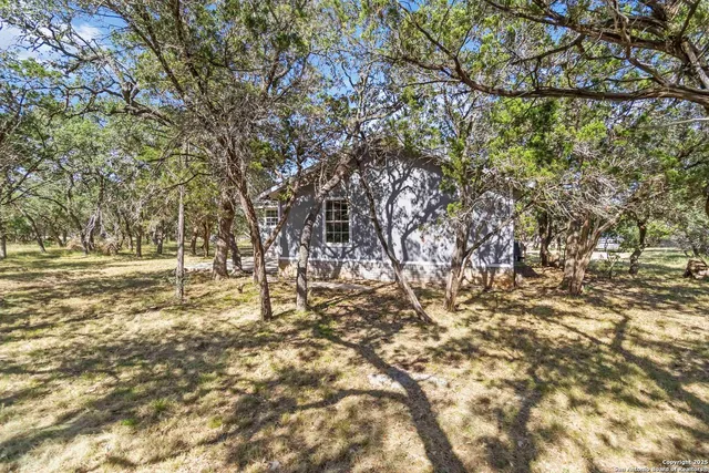 a backyard of a house with large trees