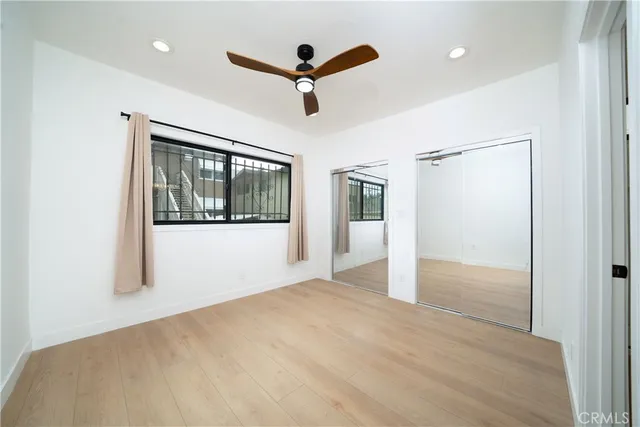 a view of a livingroom with a ceiling fan & hardwood floor
