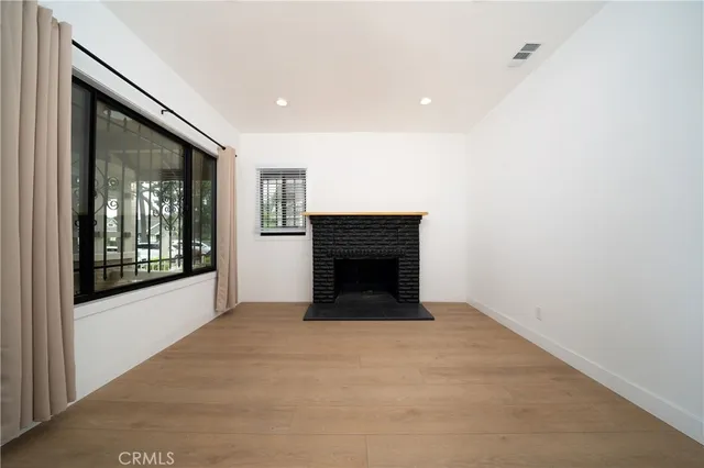 a view of an empty room with a fireplace