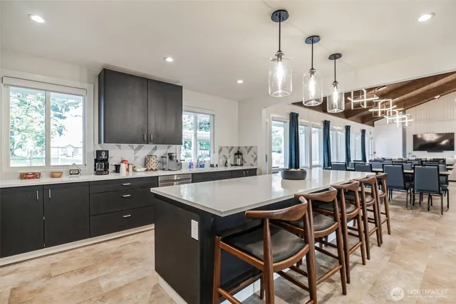 a living room with furniture a chandelier and a wooden floor