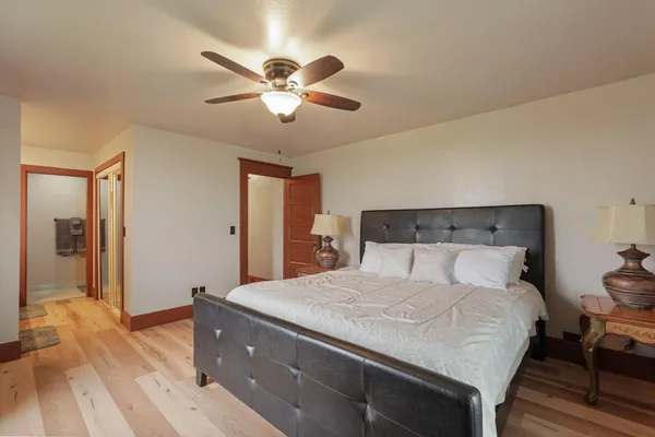 a bedroom with a large bed and a chandelier