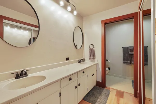 a bathroom with a double vanity sink and a mirror