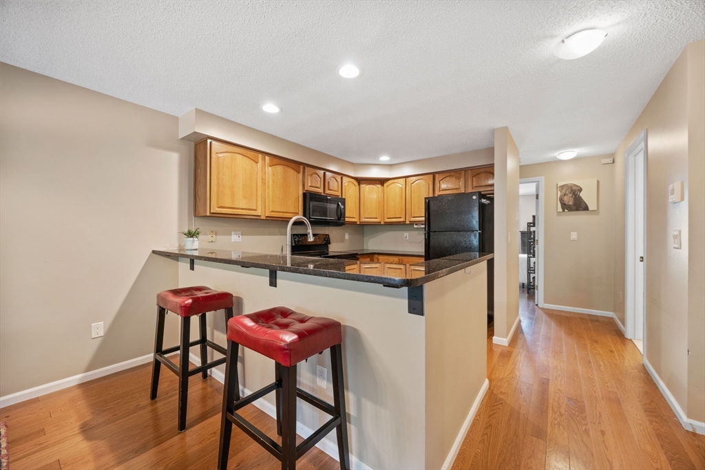 120 Abington Road, Unit 120 Danvers, MA 01923 - Photo 13 of 31 a kitchen with a table and chairs in it