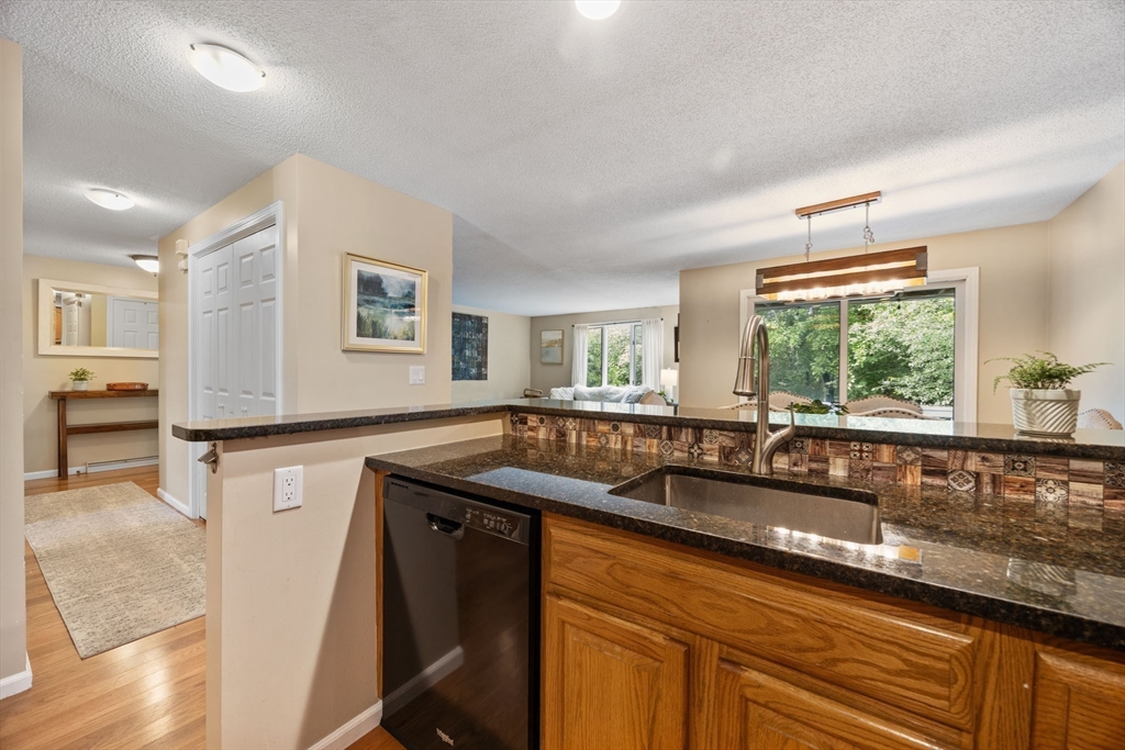 120 Abington Road, Unit 120 Danvers, MA 01923 - Photo 15 of 31 a kitchen with granite countertop a sink and a stove top oven