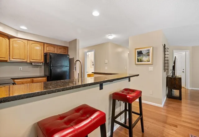 a room with furniture pool table and wooden floor