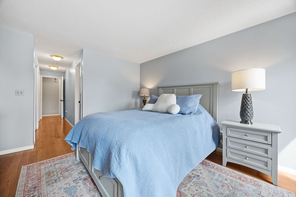 120 Abington Road, Unit 120 Danvers, MA 01923 - Photo 17 of 31 a bedroom with a bed and a night stand