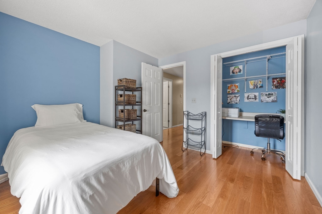 120 Abington Road, Unit 120 Danvers, MA 01923 - Photo 20 of 31 a spacious bedroom with a bed and a wooden floor