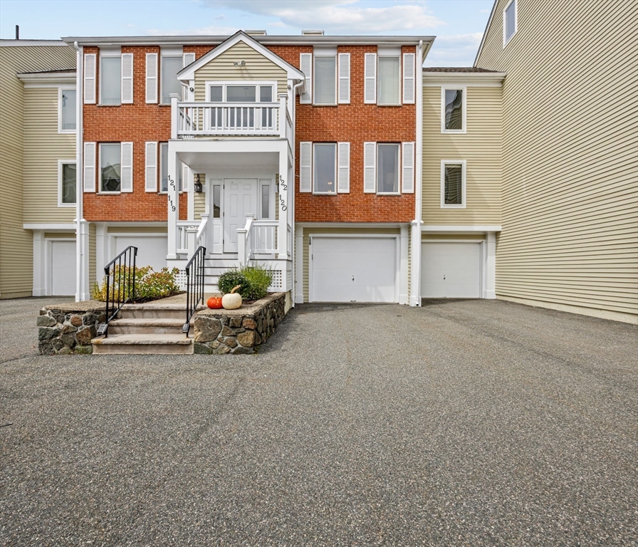 120 Abington Road, Unit 120 Danvers, MA 01923 - Photo 2 of 31 a front view of a house with a garage