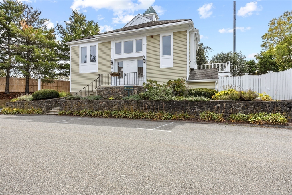 120 Abington Road, Unit 120 Danvers, MA 01923 - Photo 25 of 31 a front view of a house with a yard and outdoor seating