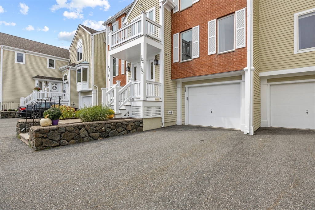 120 Abington Road, Unit 120 Danvers, MA 01923 - Photo 3 of 31 a view of a blue house with many windows