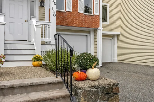 a view of a brick house with potted plants