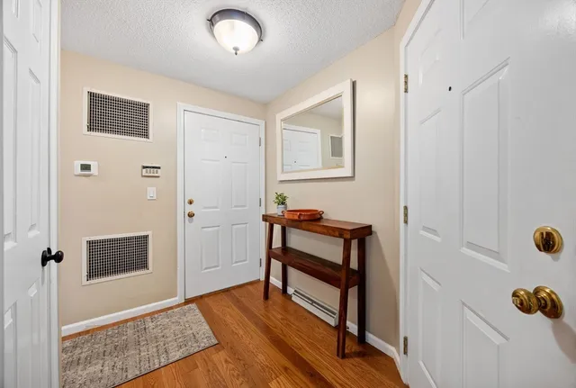 a view of room with furniture and wooden floor
