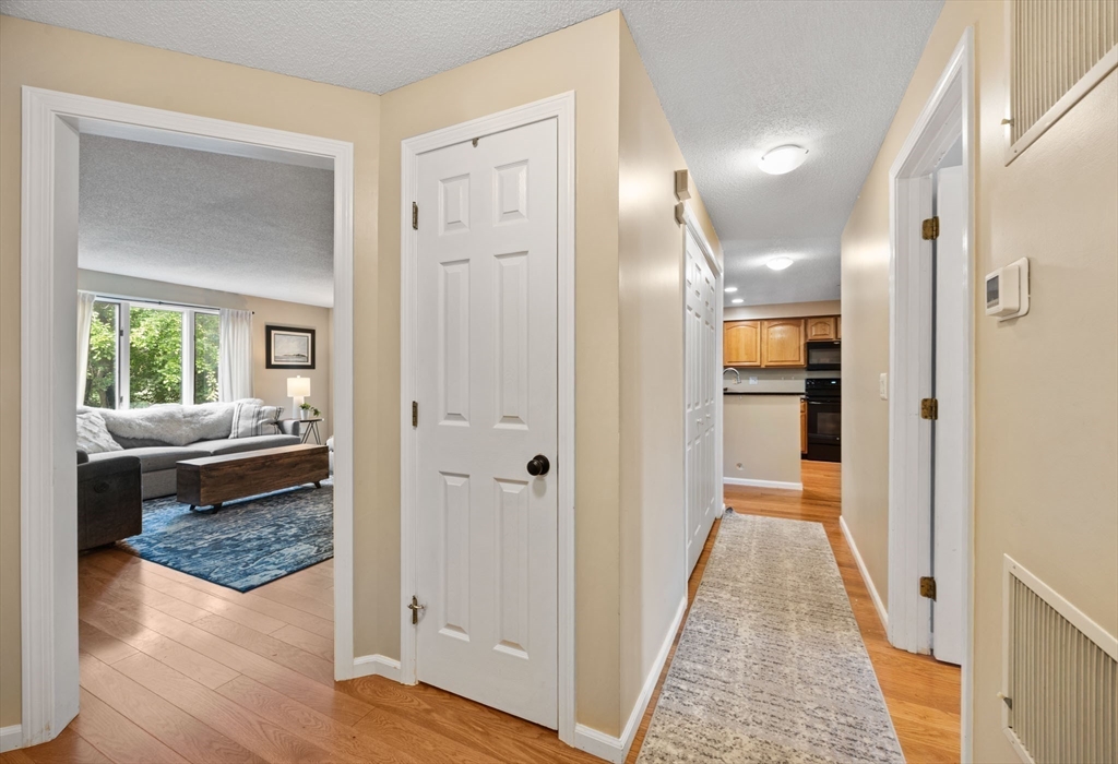 120 Abington Road, Unit 120 Danvers, MA 01923 - Photo 6 of 31 a view of a hallway view with wooden floor and a bathroom