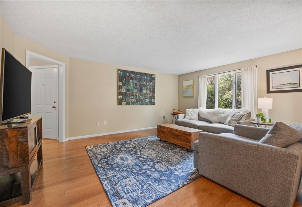 120 Abington Road, Unit 120 Danvers, MA 01923 - Photo 7 of 31 a living room with furniture and a flat screen tv
