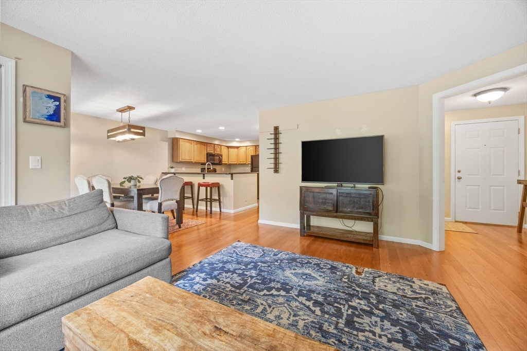 120 Abington Road, Unit 120 Danvers, MA 01923 - Photo 8 of 31 a living room with furniture and a flat screen tv