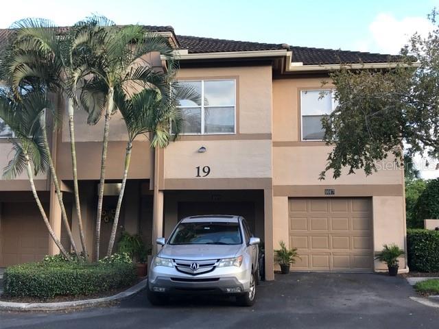 1017 Normandy Trace Road, Unit 1017 Tampa, FL 33602 - Photo 1 of 1 a car parked in front of white house