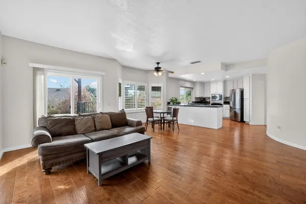a living room with furniture and kitchen view